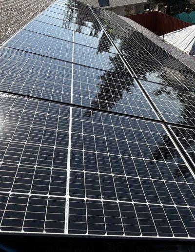 Protective bird proof wire mesh installed on residential solar panels to deter pigeons and prevent nesting under arrays on tile roofs in Porterville.